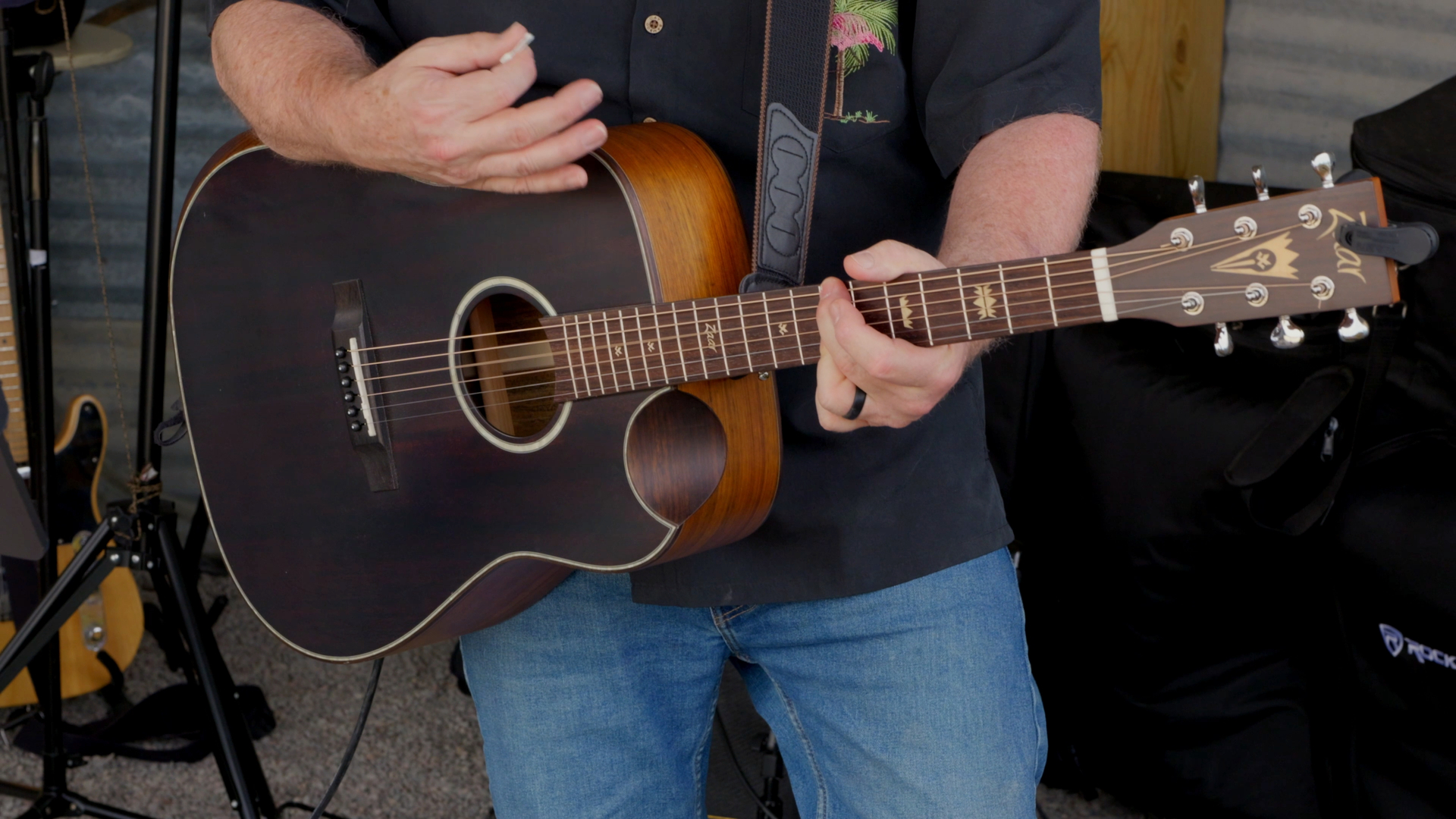 Close-up of an acoustic guitarist strumming on stage