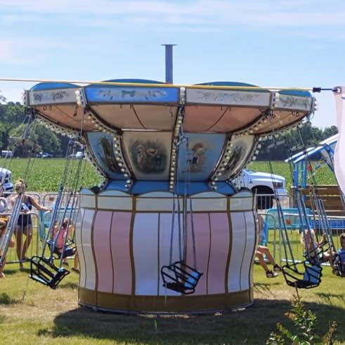 Hand-painted swing carousel ride during the day