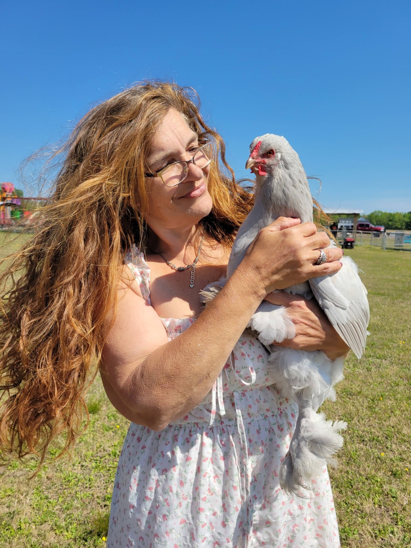 Local farmer holding a fluffy chicken at the vendor market