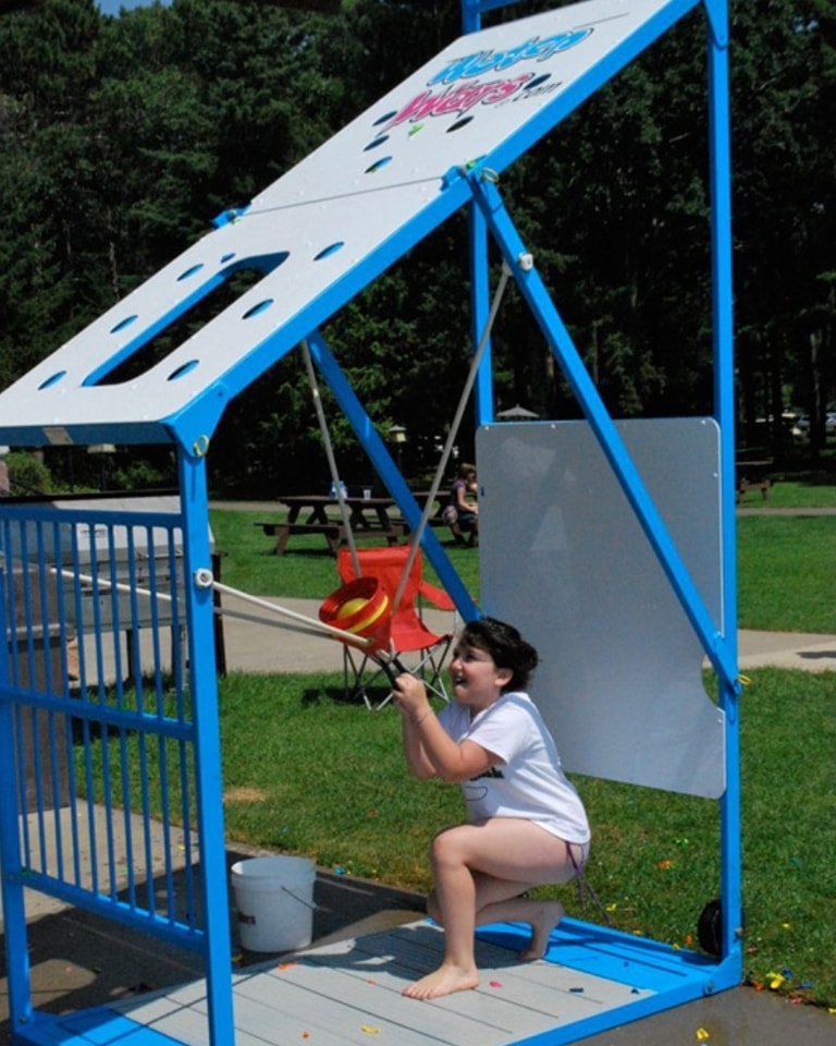 Kids battling in the Water Wars splash zone with a bungee jumper soaring in the background
